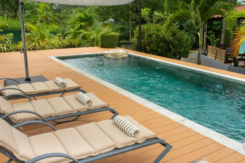 Contemporary poolside decks by Deck Builders Palmerston North with stylish loungers